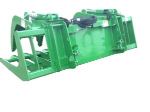 A John Deere Brush Grapple Bucket, a green metal agricultural attachment with hydraulic arms, is likely used for lifting or moving materials.