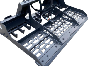 A Skid Steer Land Leveler attachment is shown on a concrete surface with grass in the background.